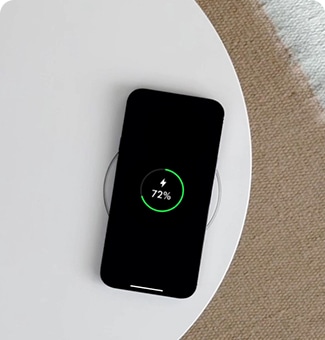 Phone charging wirelessly on top of AeroFurniture.